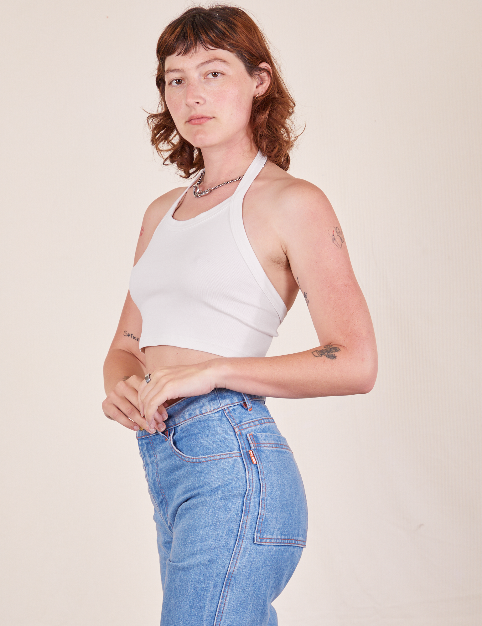 Side view of Halter Top in Vintage Tee Off-White and light wash Frontier Jeans worn by Alex