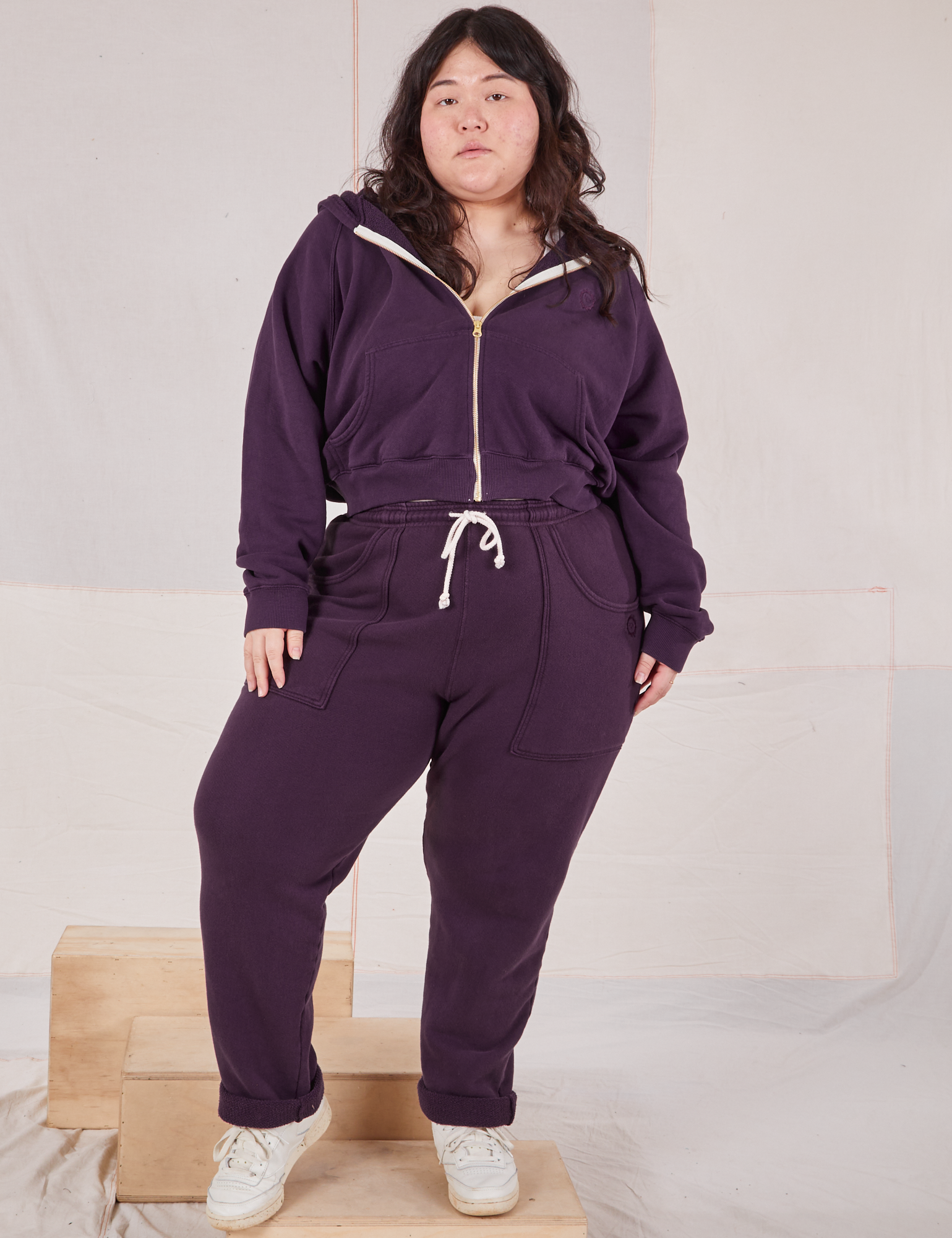 Ashley is wearing Rolled Cuff Sweat Pants in Nebula Purple and matching Cropped Zip Hoodie