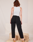 Back view of Heavyweight Trousers in Basic Black and Cropped Tank Top in vintage tee off-white worn by Alex.