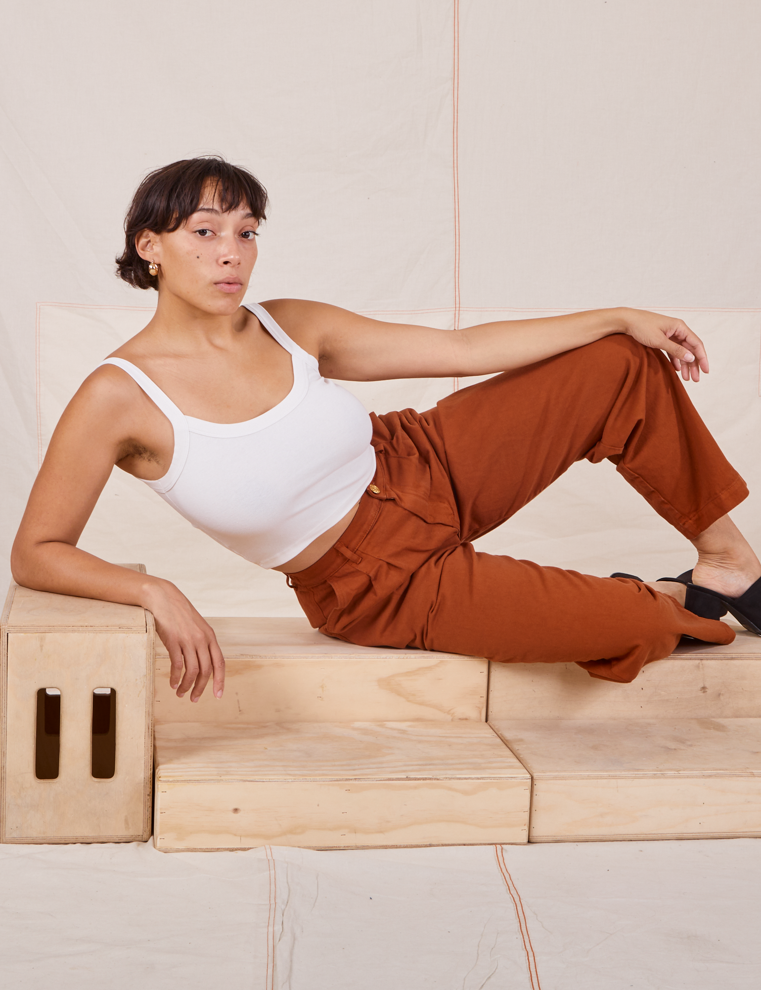Tiara is wearing Heavyweight Trousers in Burnt Terracotta and Cropped Cami in vintage tee off-white