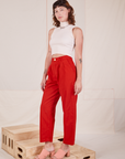 Alex is 5'8" and wearing XXS Heavyweight Trousers in Mustang Red paired with vintage off-white Sleeveless Turtleneck