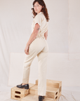 Heritage Short Sleeve Jumpsuit in Natural angled back view on Alex