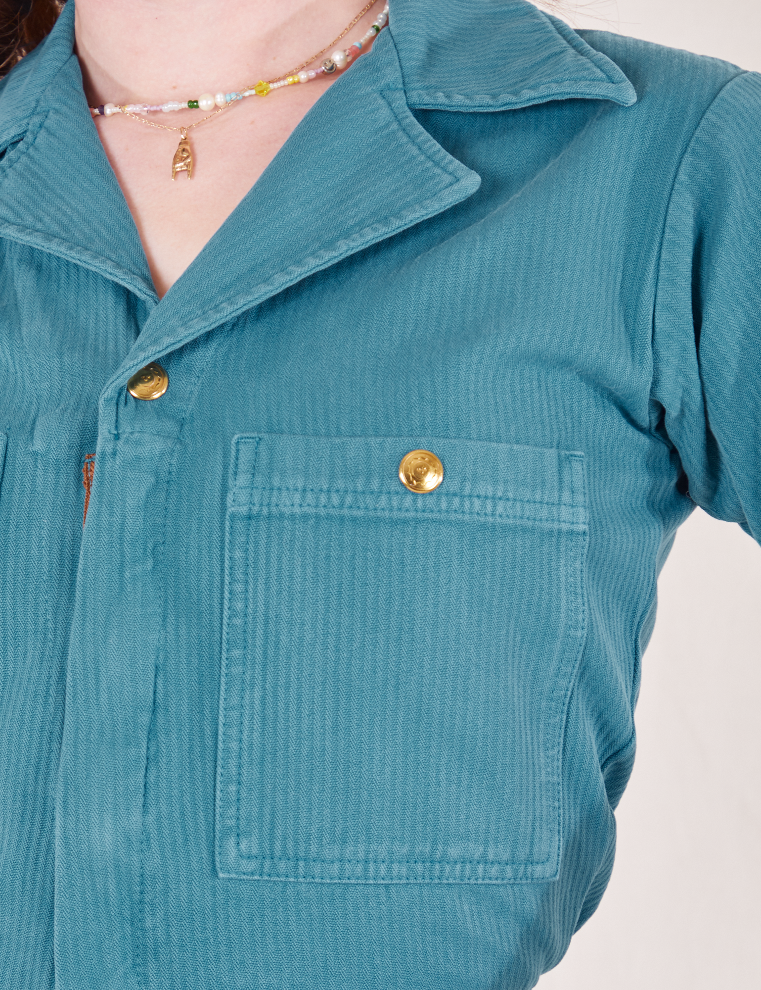 Front close up of Heritage Short Sleeve Jumpsuit in Marine Blue worn by Alex