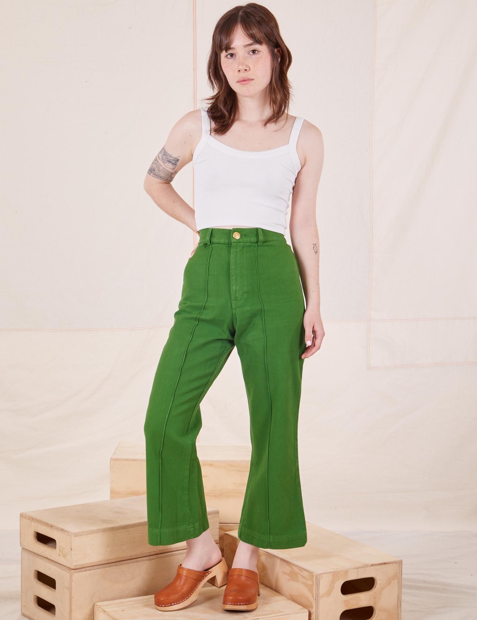 Hana is 5&#39;3&quot; and wearing XXS Petite Heritage Westerns in Lawn Green paired with Cropped Cami in vintage tee off-white 