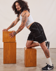 Jesse is wearing Carpenter Shorts in Basic Black and Cropped Tank in vintage tee off-white