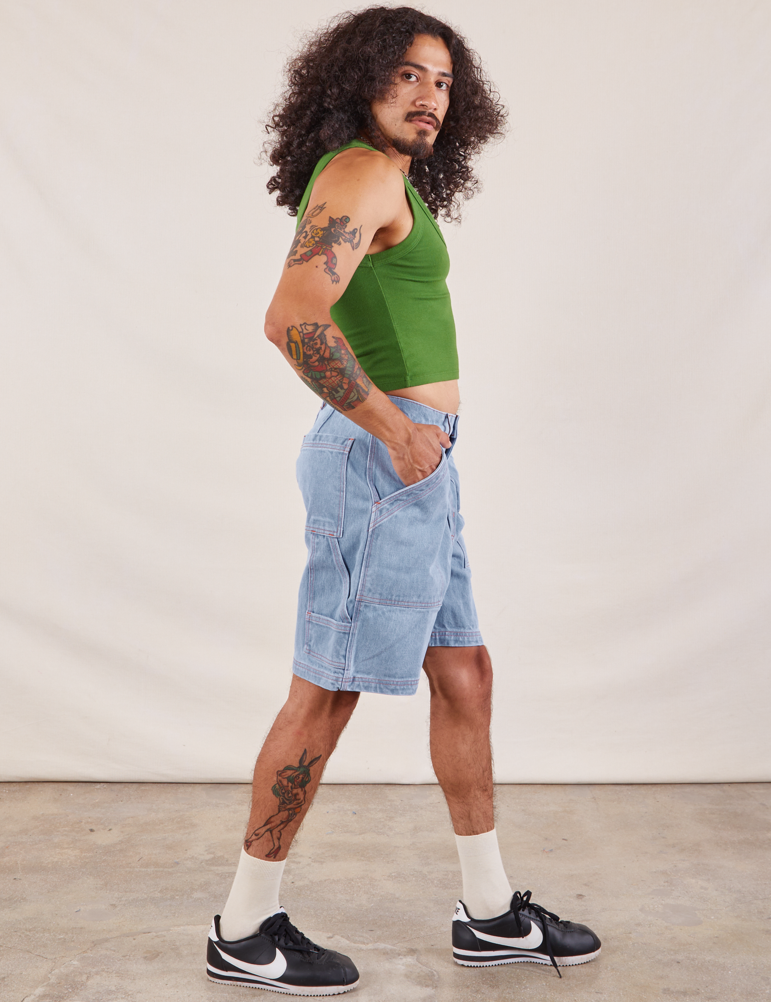 Side view of Carpenter Shorts in Light Wash and lawn green Cropped Tank on Jesse