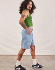 Side view of Carpenter Shorts in Light Wash and lawn green Cropped Tank on Jesse