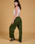 Angled back view of Baggy Mid-Rise Trousers in Evergreen on Alex