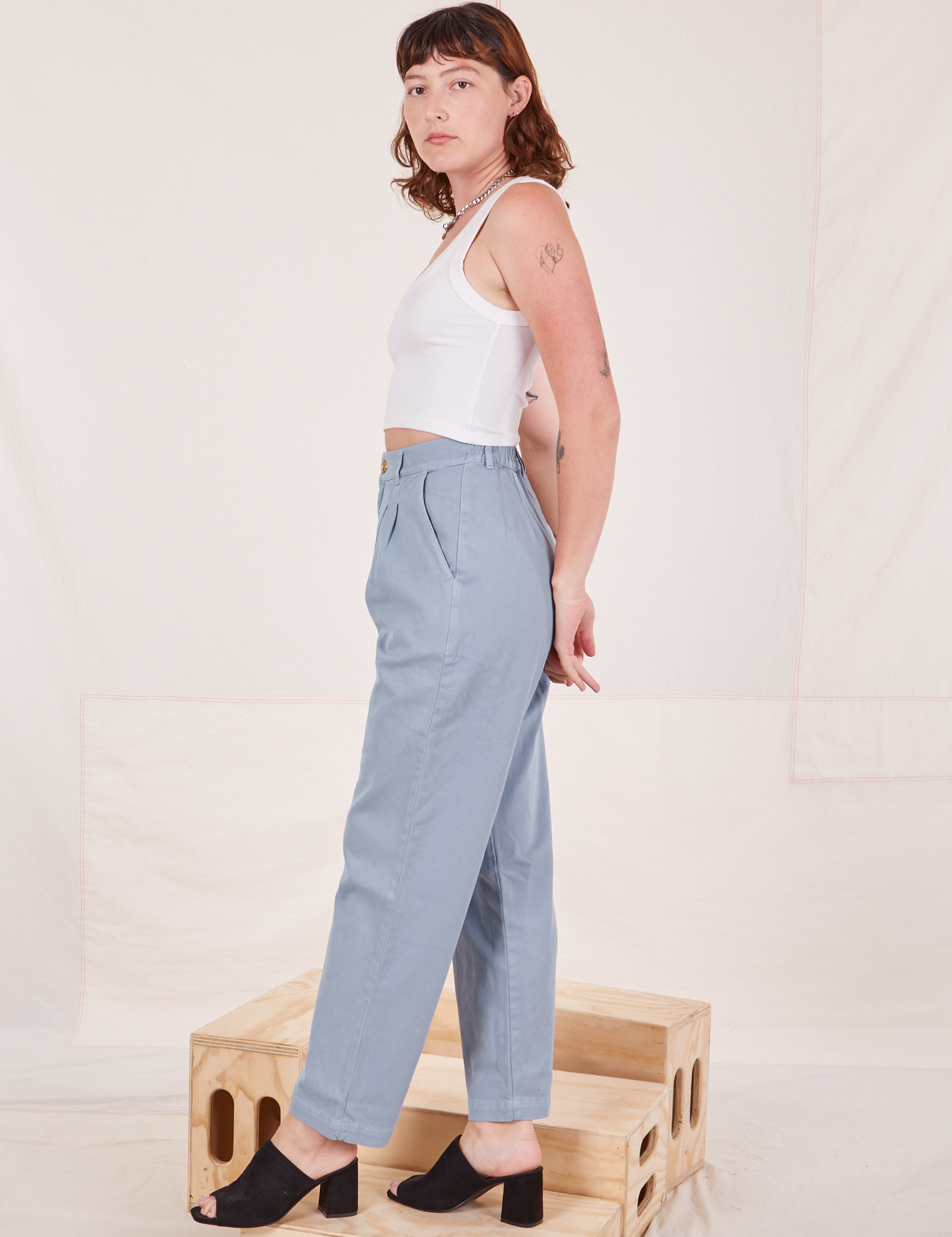 Side view of Organic Trousers in Periwinkle and Cropped Tank Top in vintage tee off-white worn by Alex