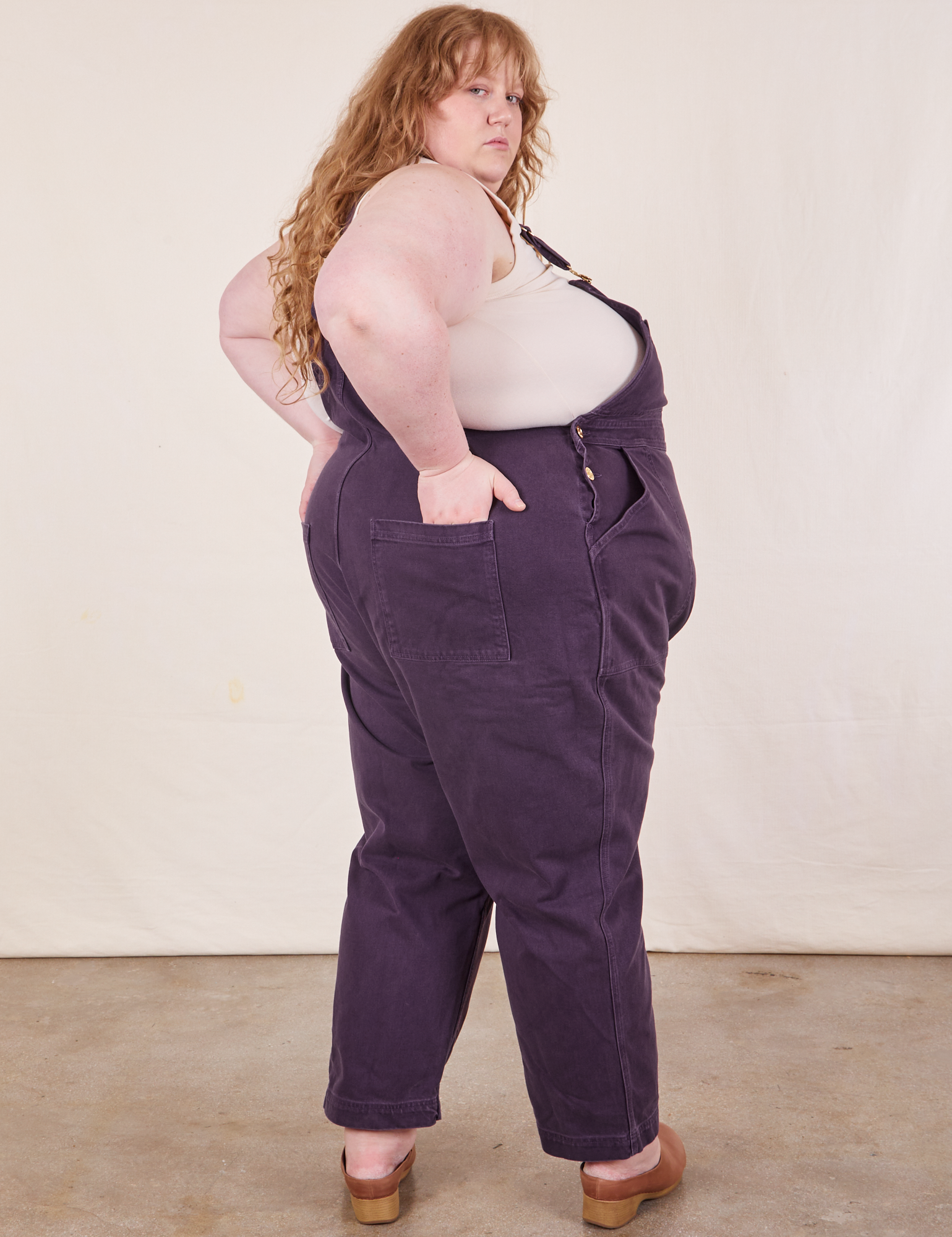 Angled back view of Original Overalls in Mono Nebula Purple worn by Catie