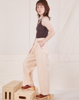Side view of Heritage Trousers in Vintage Off-White and espresso brown Tank Top worn by Hana
