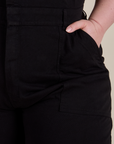 Close up of Ashley's hand in the front pocket of Short Sleeve Jumpsuit in Basic Black