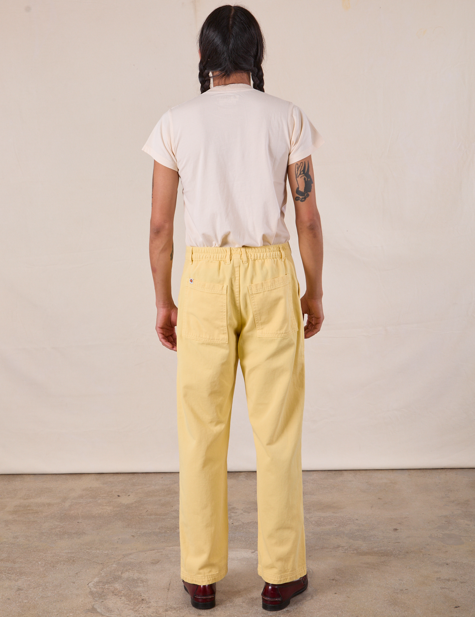 Back view of Work Pants in Butter Yellow and Organic Vintage Tee in Vintage Tee Off-White