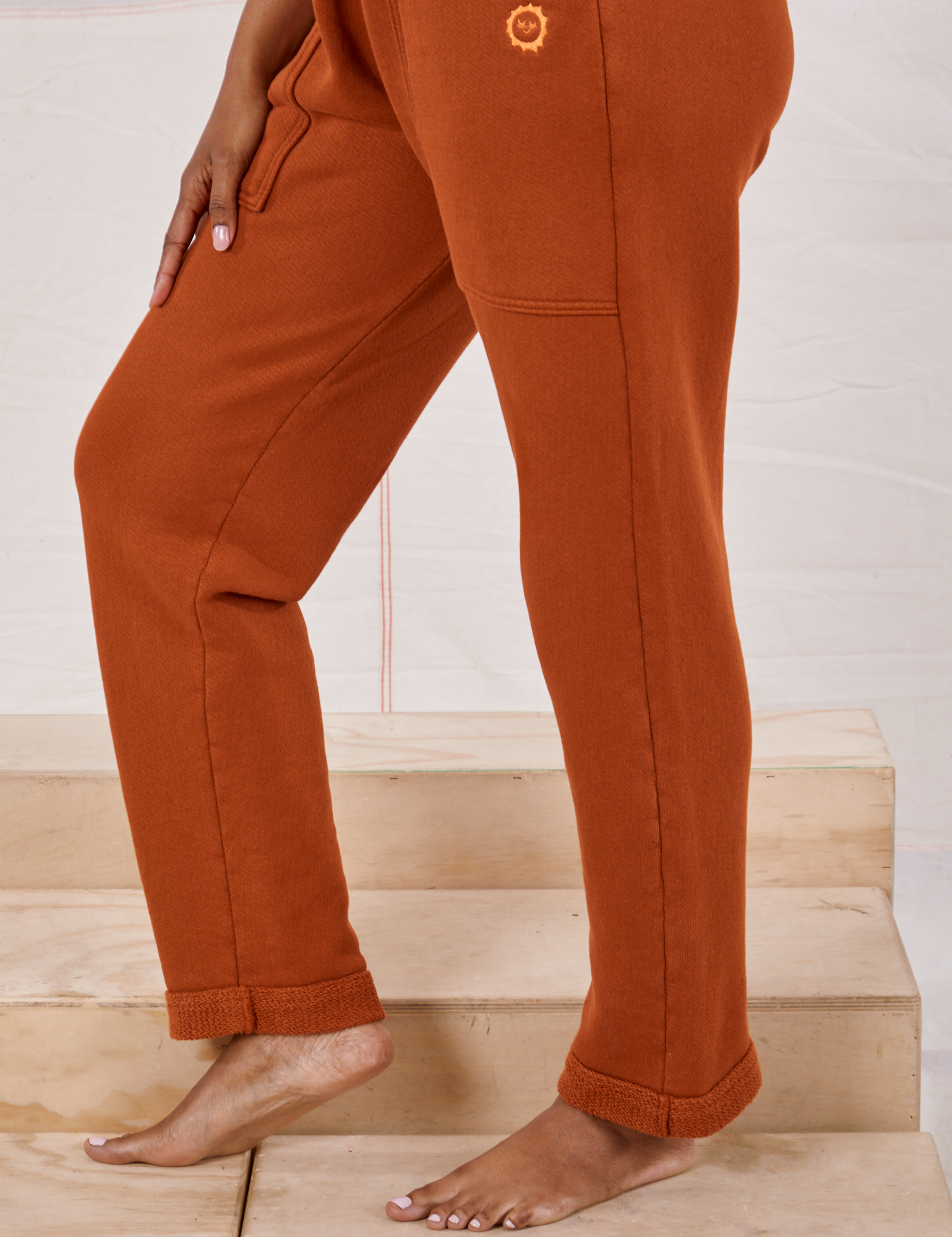 Rolled Cuff Sweat Pants in Burnt Terracotta side view close up on Kandia