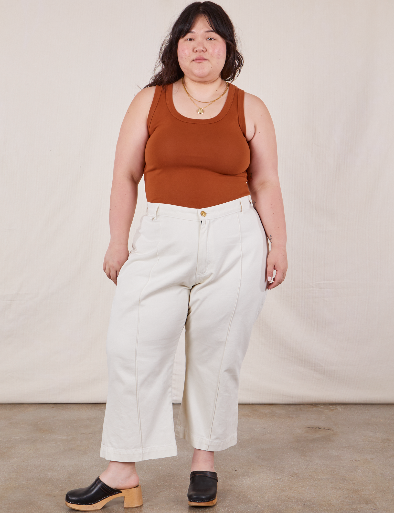 Ashley is wearing The Tank Top in Burnt Terracotta tucked into vintage tee off-white Petite Western Pants