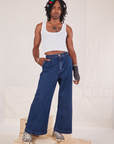 Jerrod is 6'3" and wearing S Indigo Wide Leg Trousers in Dark Wash paired with vintage off-white Cropped Tank Top