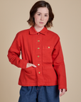 Hana is wearing a buttoned up Denim Work Jacket in Mustang Red