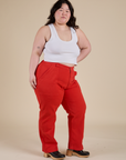 Angled front view of Work Pants in Mustang Red and Cropped Tank in Vintage Tee White on Ashley