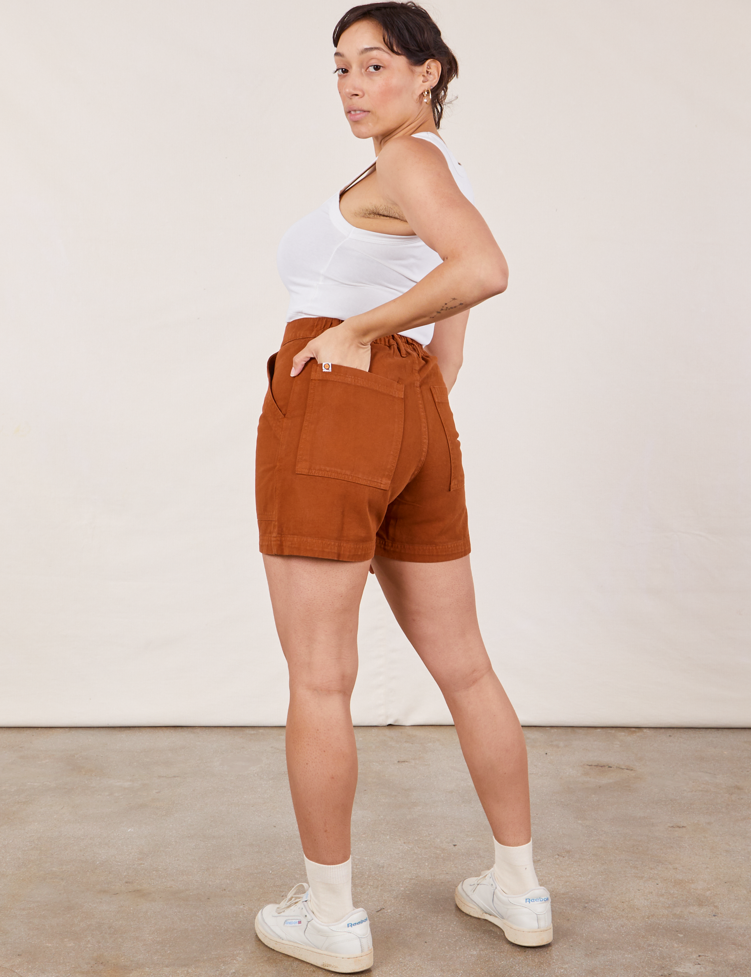 Angled back view of Classic Work Shorts in Burnt Terracotta and Cropped Tank Top in vintage tee off-white  on Tiara