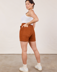 Angled back view of Classic Work Shorts in Burnt Terracotta and Cropped Tank Top in vintage tee off-white  on Tiara