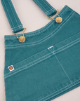 Overall Handbag in Marine Blue. White contrast stitching. Brass sun baby buttons and hardware
