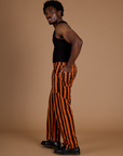 Side view of Black Stripe Work Pants in Construction Orange and black tank top on Isaac