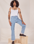 Jesse is 5'8" and wearing XS Carpenter Jeans in Light Wash paired with Cropped Cami in vintage tee off-white
