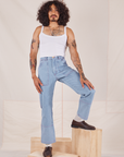 Jesse is 5'8" and wearing XS Carpenter Jeans in Light Wash paired with a vintage off-white Cami