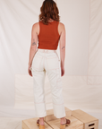 Back view of Carpenter Jeans in Vintage Tee Off-White and burnt terracotta Cropped Tank Top on Alex