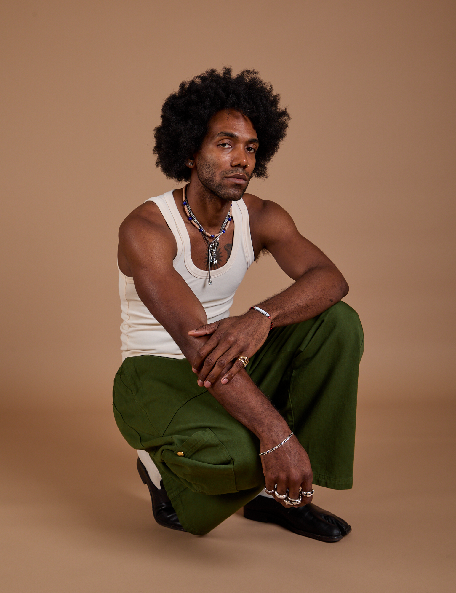 Drop Pocket Cargo Pants in Evergreen and Tank Top in vintage tee white worn by Jerrod