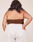 Back view of Halter Top in Fudgesicle Brown and vintage off-white Western Pants worn by Alicia. She has her left hand in the back pant pocket.