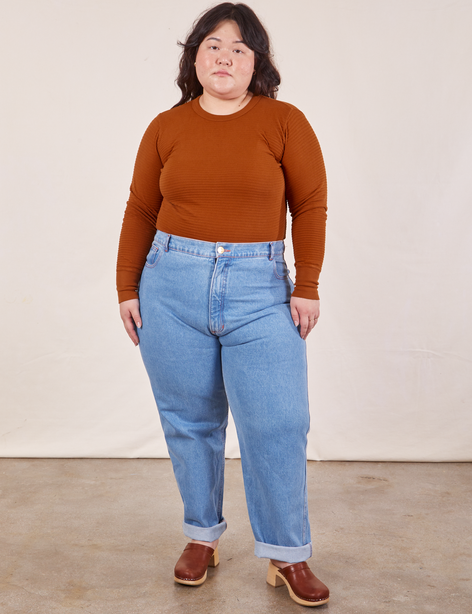 Ashley is wearing Honeycomb Thermal in Burnt Terracotta tucked into Frontier Jeans