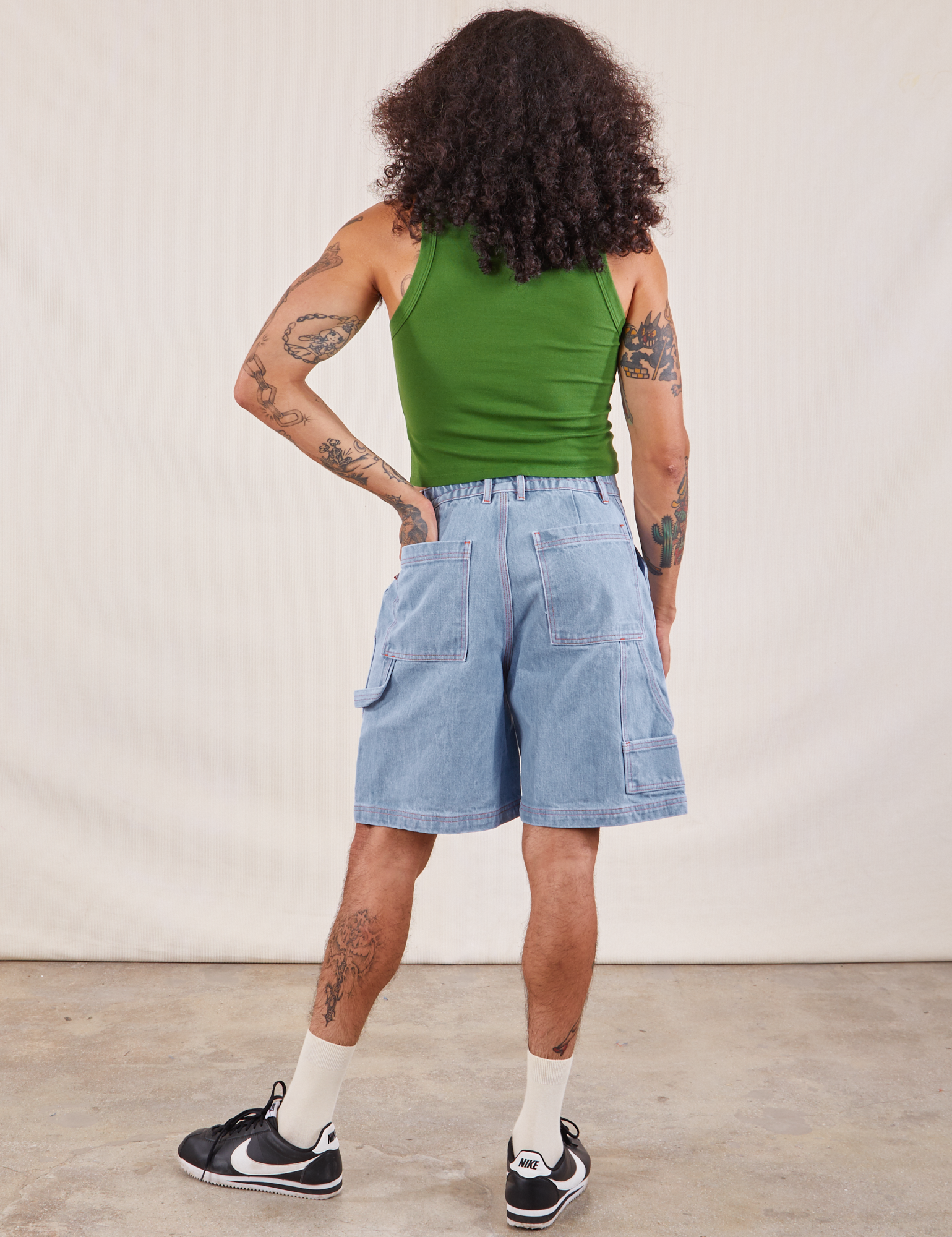 Back view of Carpenter Shorts in Light Wash and lawn green Cropped Tank on Jesse