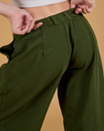 Baggy Mid-Rise Trousers in Evergreen back close up on Alex