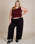 Juliet is wearing Muscle Tee in Red Wine and black Drop Pocket Cargo Pants