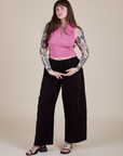 Sydney is wearing Muscle Tee in Bubblegum Pink paired with black Drop Pocket Cargo Pants