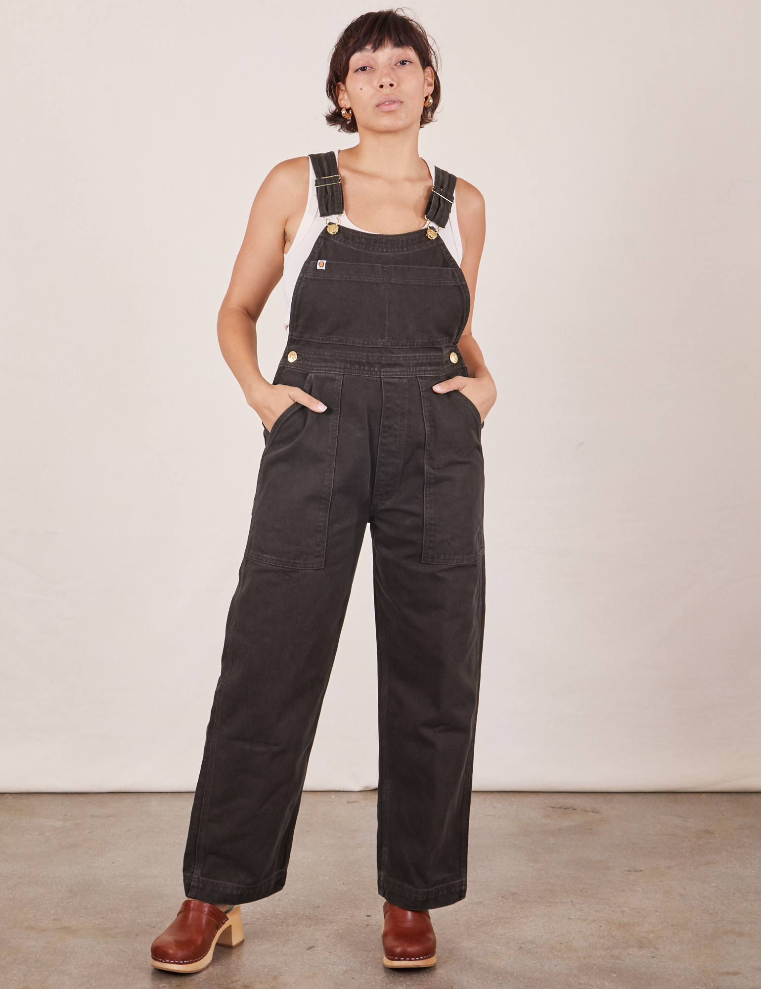 Tiara is wearing Original Overalls in Mono Espresso and Cropped Tank Top in vintage tee off-white