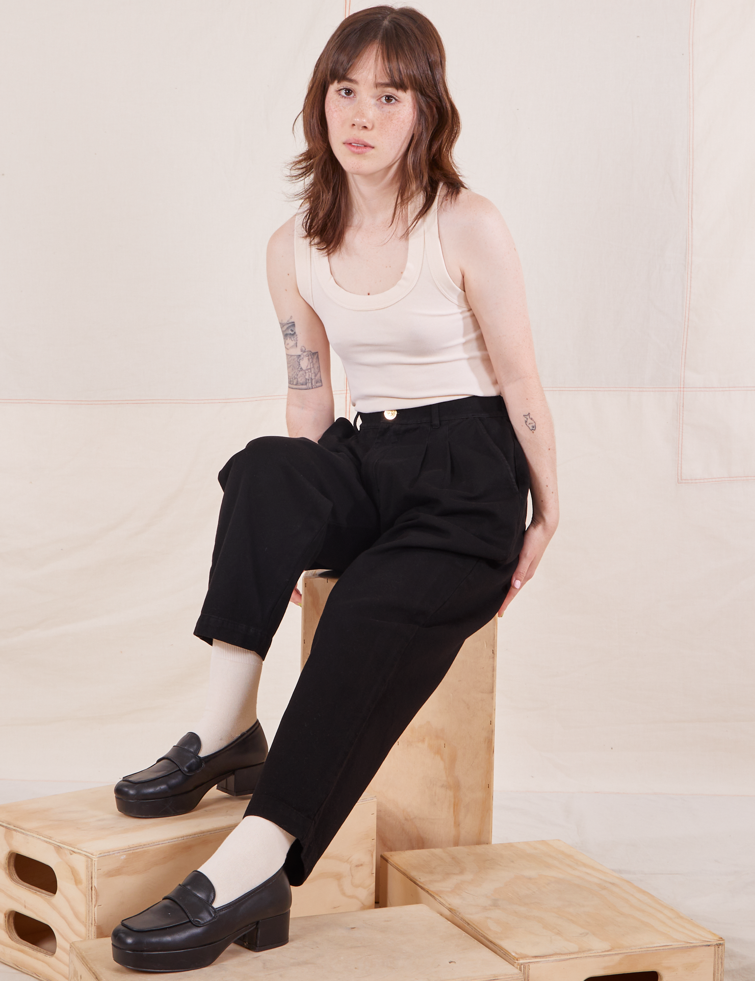 Hana is wearing Organic Trousers in Basic Black and vintage off-white Tank Top