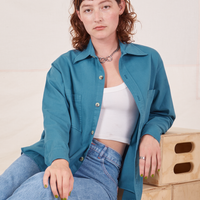 Alex is wearing Oversize Overshirt in Marine Blue with a vintage off-white Cropped Tank Top underneath