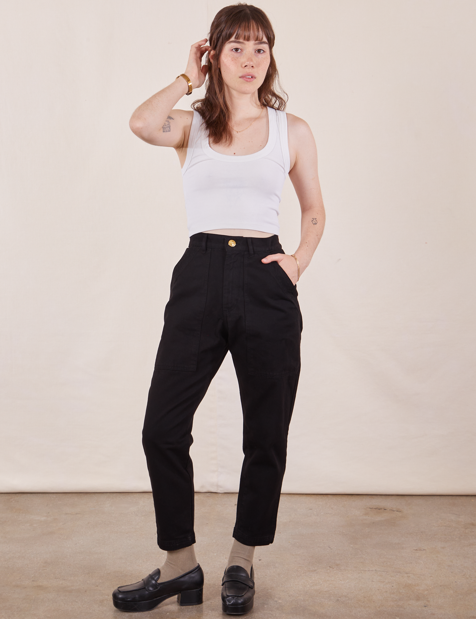 Hana is 5&#39;3&quot; and wearing XXS Petite Pencil Pants in Basic Black paired with Cropped Tank Top in vintage tee off-white