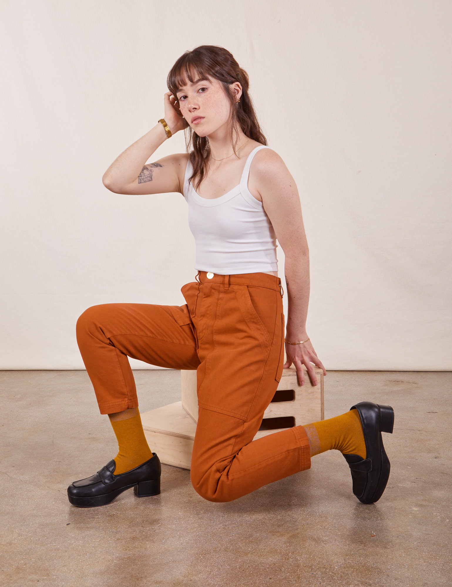 Hana is wearing Petite Pencil Pants in Burnt Terracotta and Cropped Cami in vintage tee off-white