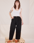 Hana is 5'3" and wearing XXS Petite Denim Trouser Jeans in Black paired with Cropped Tank Top in vintage tee off-white