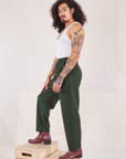 Side view of Heritage Trousers in Swamp Green and Cropped Tank Top in vintage tee off-white