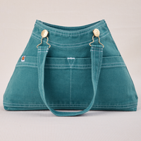 Overall Handbag in Marine Blue with handle down across front