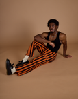 Black Stripe Work Pants in Construction Orange and black tank top on Isaac