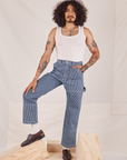Jesse is 5'8" and wearing XS Carpenter Jeans in Railroad Stripes paired with Tank Top in vintage tee off-white
