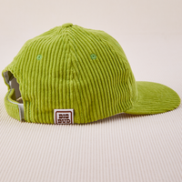 Side view of Dugout Corduroy Hat in Gross Green. Big Bud label sewn on edge of hat.