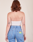 Back view of Halter Top in Vintage Tee Off-White and light wash Frontier Jeans worn by Alex