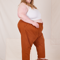 Side view of Heavyweight Trousers in Burnt Terracotta and vintage off-white Cropped Cami worn by Catie