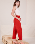 Side view of Heavyweight Trousers in Mustang Red and Sleeveless Turtleneck in vintage tee off-white worn by Alex